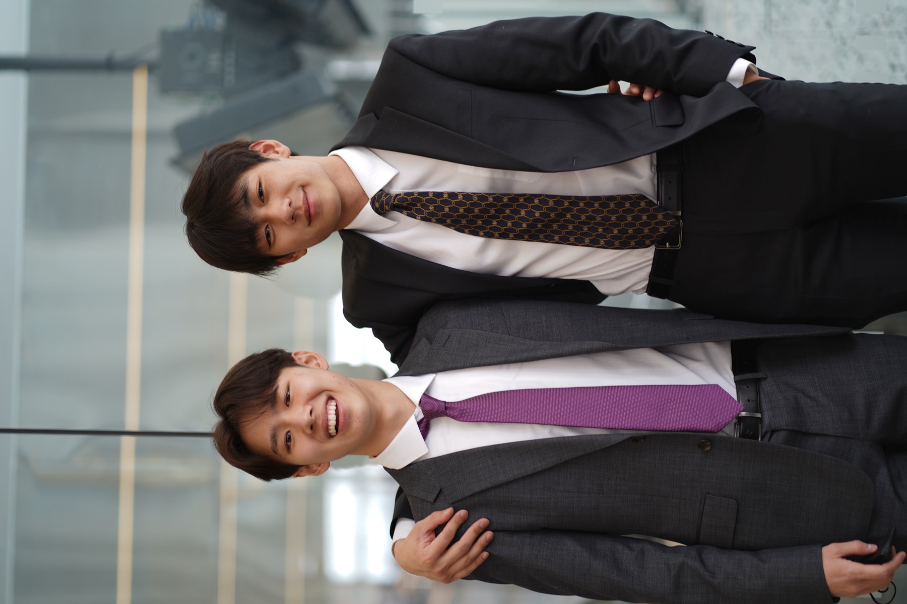 Two members arm in arm in the Sage Hall atrium